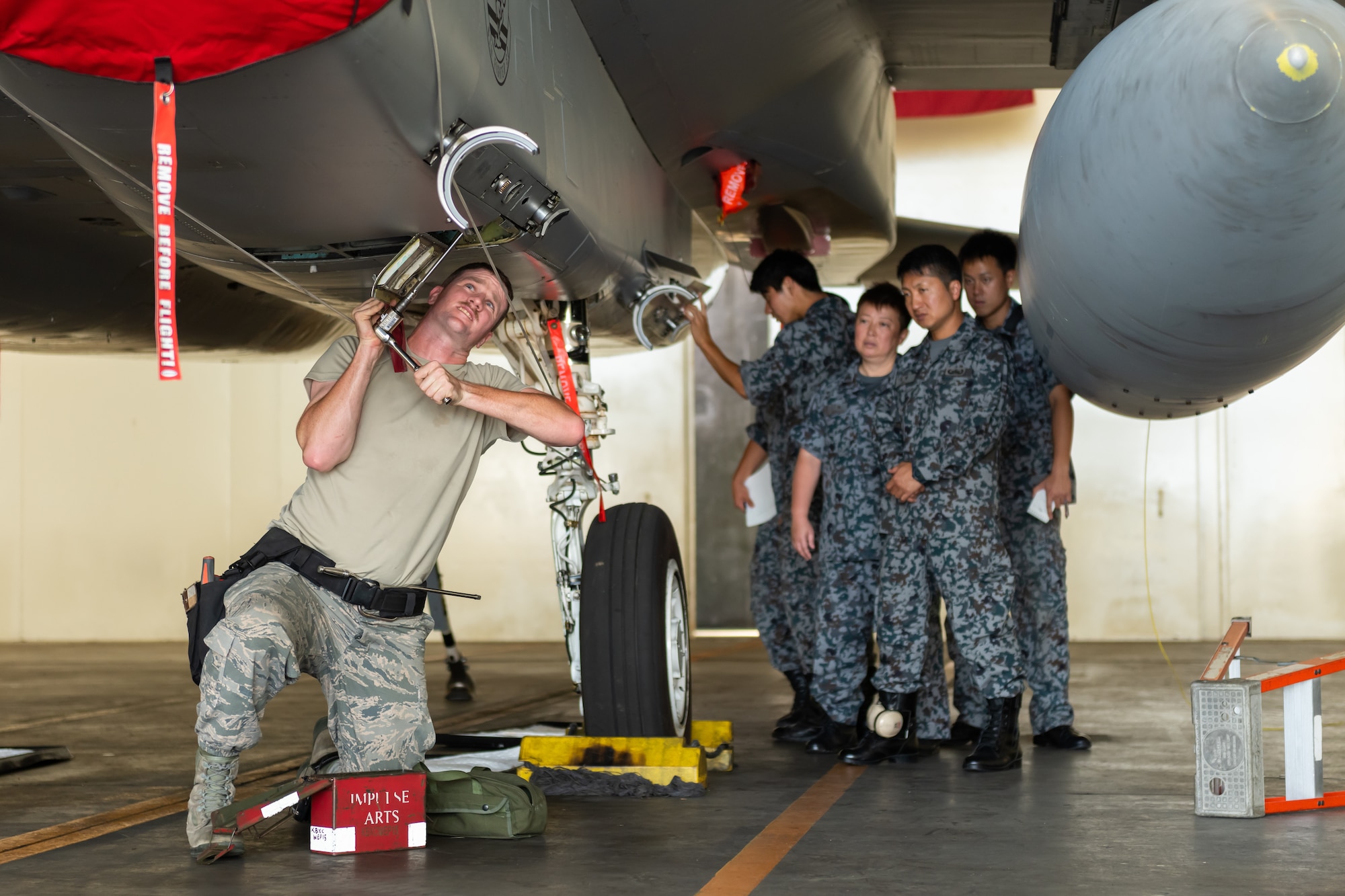 U.S. Air Force Senior Airman Jacob Johnson, 18th Maintenance Group weapons lead crew member, prepares an F-15D Eagle for weapons during the first bilateral weapons load exchange between Kadena Air Base and the Japan Air Self-Defense Force, May 23, 2019. The goal of the training is to accurately and safely load munitions while strengthening the U.S.-Japan alliance in order to secure a free-and-open Indo-Pacific. (U.S. Air Force photo by Airman 1st Class Matthew Seefeldt)