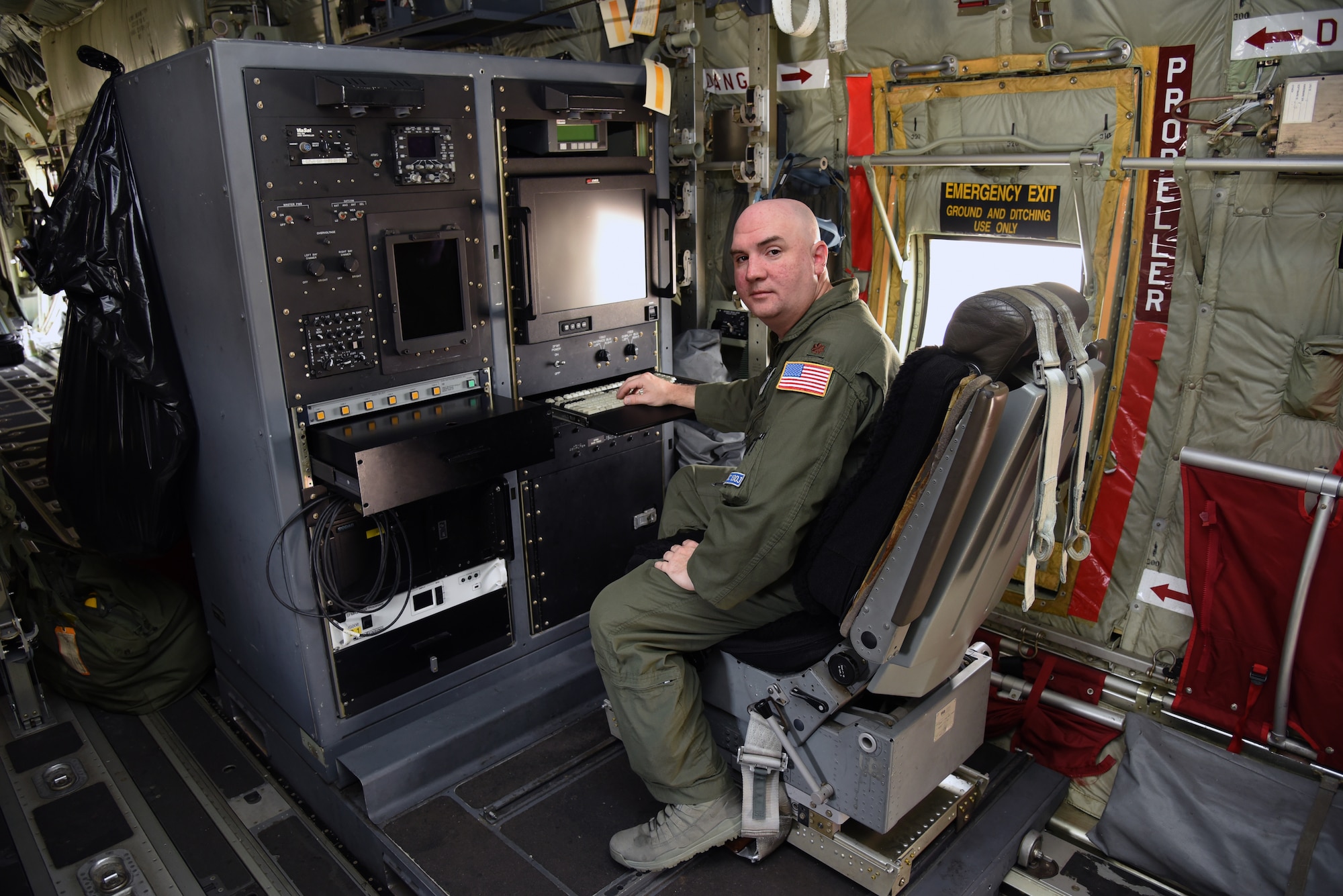 Maj. Tobi Baker, 53rd Weather Reconnaissance Squadron aerial weather reconnaissance officer, poses for a photo at the ARWO station inside of a WC-130J Super Hercules at Keesler Air Force Base, Mississippi, May 23, 2019. The ARWO acts like a flight director in a storm. He continuously monitors atmospheric data collected from the aircraft’s sensors throughout the mission. The gathered data is checked for accuracy and the information is used to guide the aircraft into the center of the storm. (U.S. Air Force photo by Tech. Sgt. Christopher Carranza)