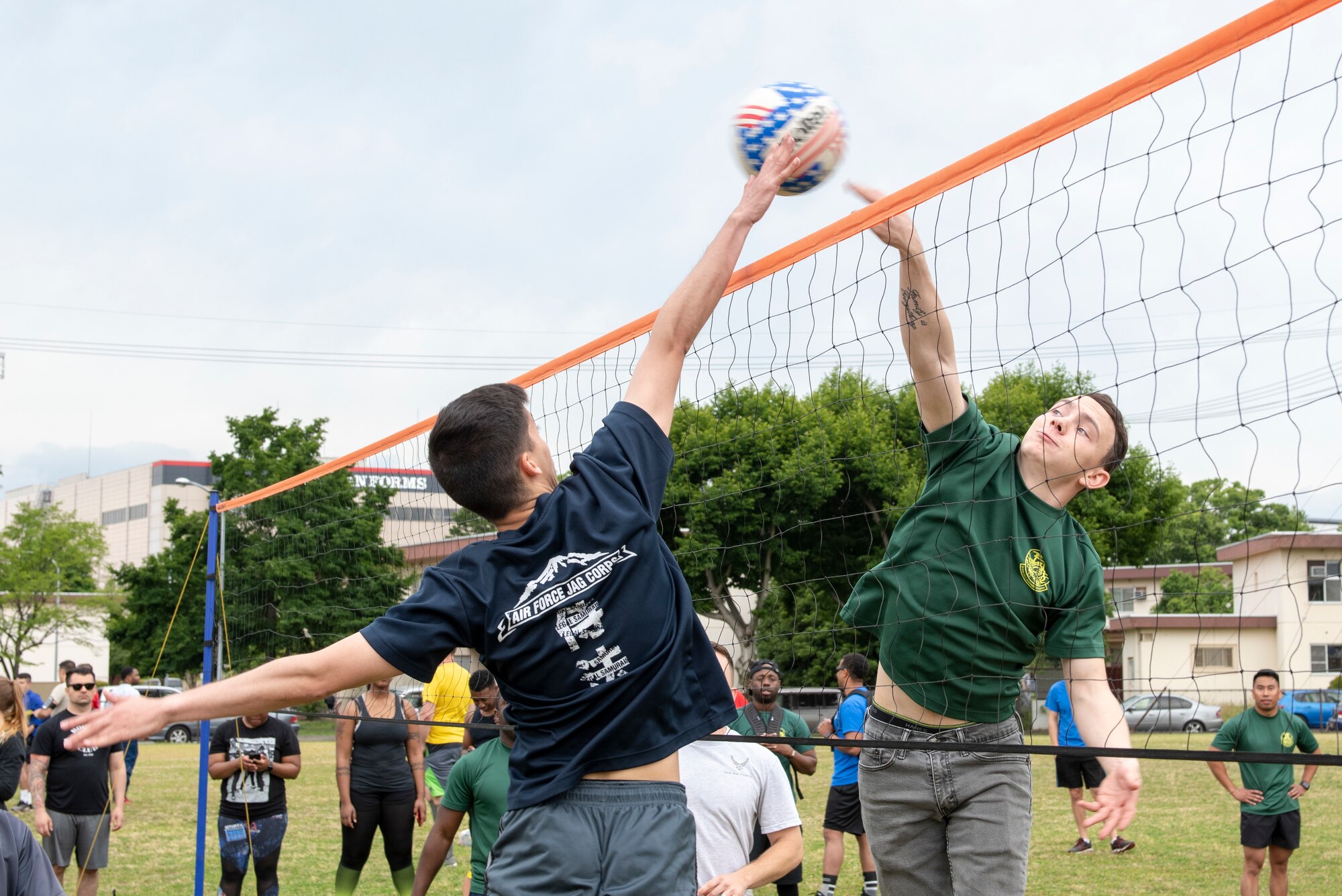 Airmen from the 374th Airlift Wing Judge Advocate and the 374th Civil Engineer Squadron face off in a volleyball game during Airman Appreciation Day at Yokota Air Base, Japan, May 31, 2019.