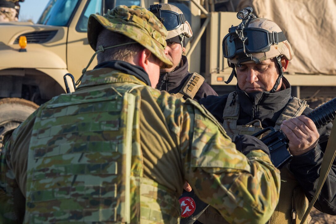An Australian soldier from Task Group Taji 8 inspects and clears an Iraqi Army (IA) soldier’s weapon before a School of Infantry NCO 2 (SINCO 2) led culminating activity at Taji Military Complex, Iraq, Jan. 20, 2019. The event was the final test for four IA battalions that have received 10 weeks’ training from the SINCO2 with oversight from Australian Army instructor assessors from Task Group Taji 8. The Coalition offers training programs include courses in areas as diverse as operational planning, counter-terrorism, logistics and sustainment, equipment maintenance, counter-IED techniques and law enforcement. The Iraqi Army School of Infantry NCO 2 recently achieved initial operating capability, meaning that the school can perform 75 percent of its operations without Coalition assistance.