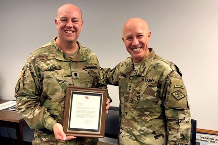 Maj. Gen. David C. Coburn, U.S. Army Financial Management Command commanding general, right, presents Lt. Col. Ralph “Mac” Crum, USAFMCOM finance accounting oversight and field operations chief, with a letter congratulating him on his selection for promotion to the rank of colonel at the Maj. Gen. Emmet J. Bean Federal Center in Indianapolis May 21, 2019. In total, the Army considered 2,985 lieutenant colonels for promotion with only 14.2 percent selected.