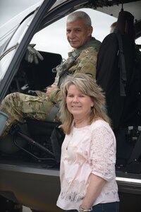 New York Army National Guard Sgt. Maj. Joseph Marino sits with his wife Brenda, in Latham, N.Y., May 29, 2019, after returning from a final flight in a UH-72 light utility helicopter.  Marino, a federal technician maintenance supervisor, was honored with a final flight because he was retiring after 33 years of service at the New York Army National Guard's Latham flight facility.