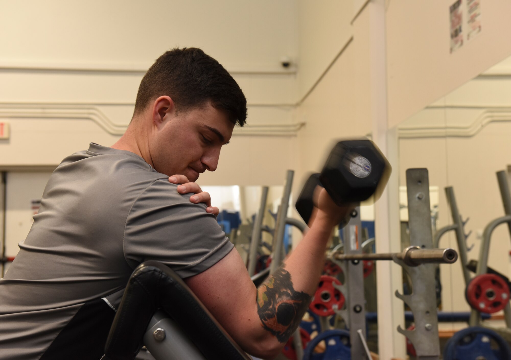 An Airman performs a bicep curl during a strength and conditioning class at Larger than Life Fitness Center May 30, 2019, at Incirlik Air Base, Turkey. During their time at Incirlik, many Airmen focus on achieving their fitness goals, which can include becoming faster, stronger or more flexible. (U.S. Air Force photo by Staff Sgt. Matthew J. Wisher)