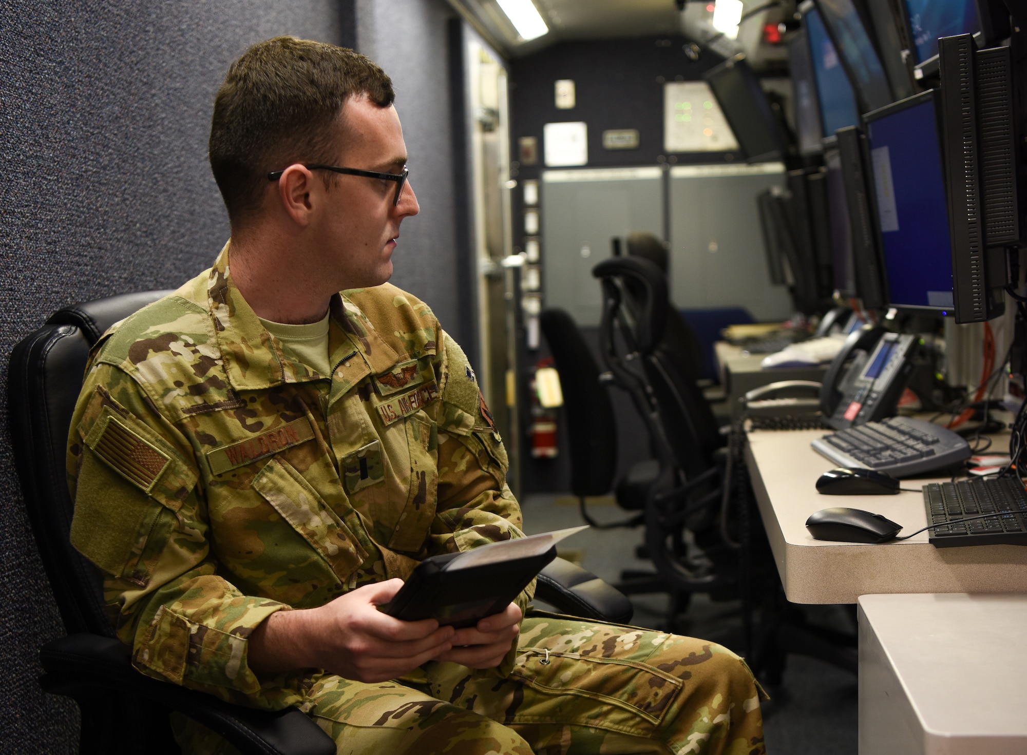 First Lt. Chirstopher Waldron, 348th Reconnaissance Squadron RQ-4 mission commander, examines the cabilities of an electronic flight book while inside an RQ-4 Global Hawk cockpit May 13, 2019 at Grand Forks Air Force Base, North Dakota. The classification procedures for Grand Forks AFB’s EFB program allow pilots to access their EFB’s in secure areas to aid in mission completion.  (U.S. Air Force photo by Senior Airman Elijaih Tiggs)
