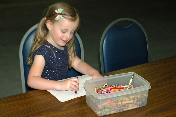 Young girl coloring during Family Day on May 18, 2019, at the National Museum of the U.S. Air Force. (U.S. Air Force photo)
