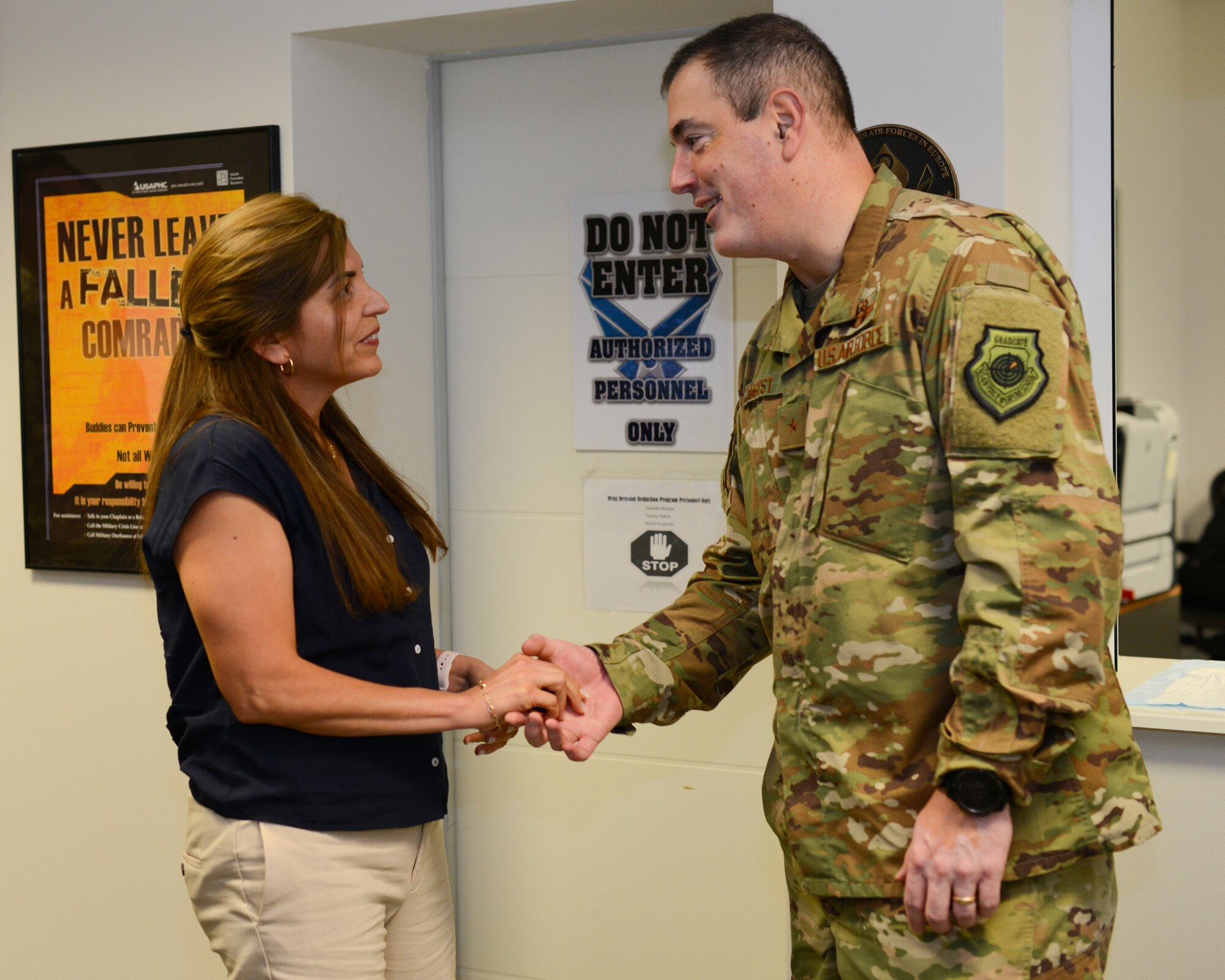 U.S. Air Force Brig. Gen. Mark R. August, 86th Airlift Wing commander, shakes hands with Yessica Sutton, the drug testing program administrative manager on Ramstein Air Base, Germany, May 30, 2019.