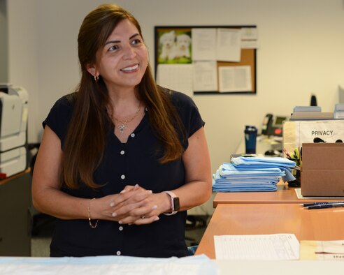 Yessica Sutton, the drug testing program administrative manager, smiles behind the reception desk on Ramstein Air Base, Germany, May 30, 2019.