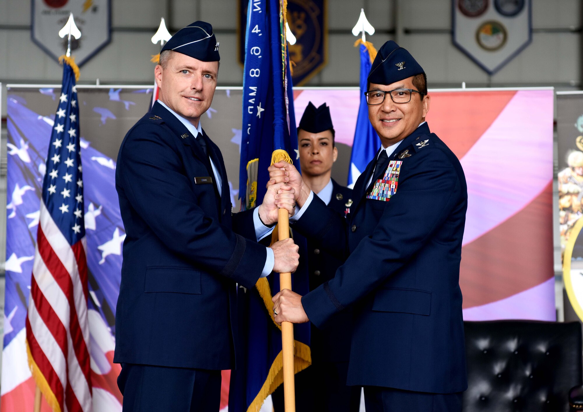 U.S. Col. Troy Pananon (right), 100th Air Refueling Wing incoming commander, assumes command from Maj. Gen. John Wood, Third Air Force commander, during a change of command ceremony at RAF Mildenhall, England, May 31, 2019. Pananon previously served as the 6th Air Mobility Wing vice commander at MacDill Air Force Base, Florida. (U.S. Air Force photo by Airman 1st Class Brandon Esau)