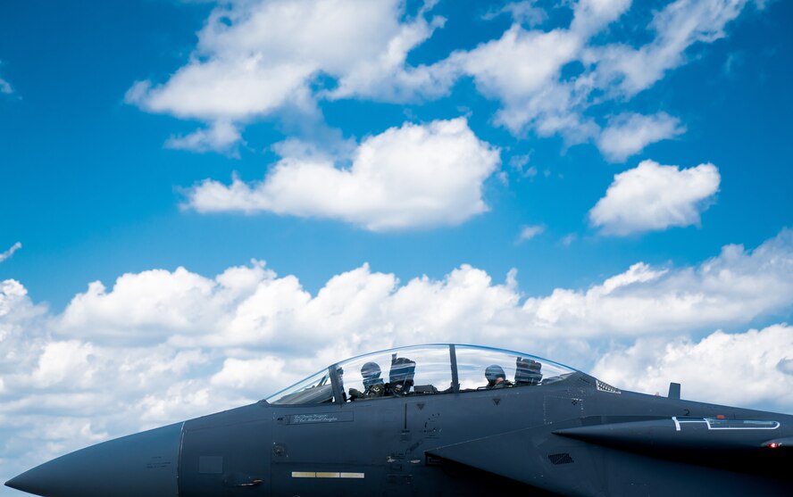 Pilots recover and gather their belongings after flying in an F-15