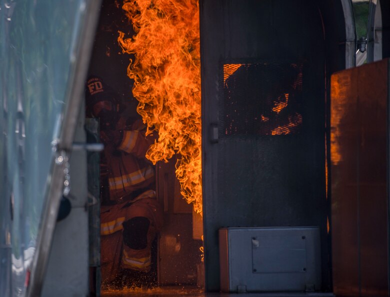 A firefighter puts out a fire in a mobile aircraft fire training unit