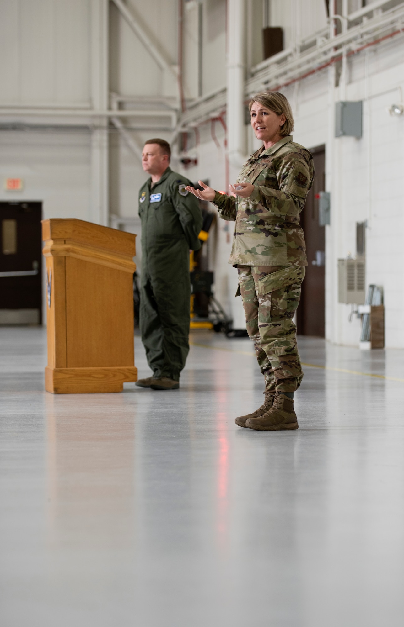 Chief Master Sgt. Kathleen McCool, 509th Bomb Wing command chief, introduced herself to an audience during a commander's call assembly on May 23, 2019, at Whiteman Air Force Base, Missouri. McCool and Col. Jeffrey Schreiner, the 509th BW commander, took the opportunity to emphasize the importance of Airman wellness. (U.S. Air Force photo by Staff Sgt. Kayla White)