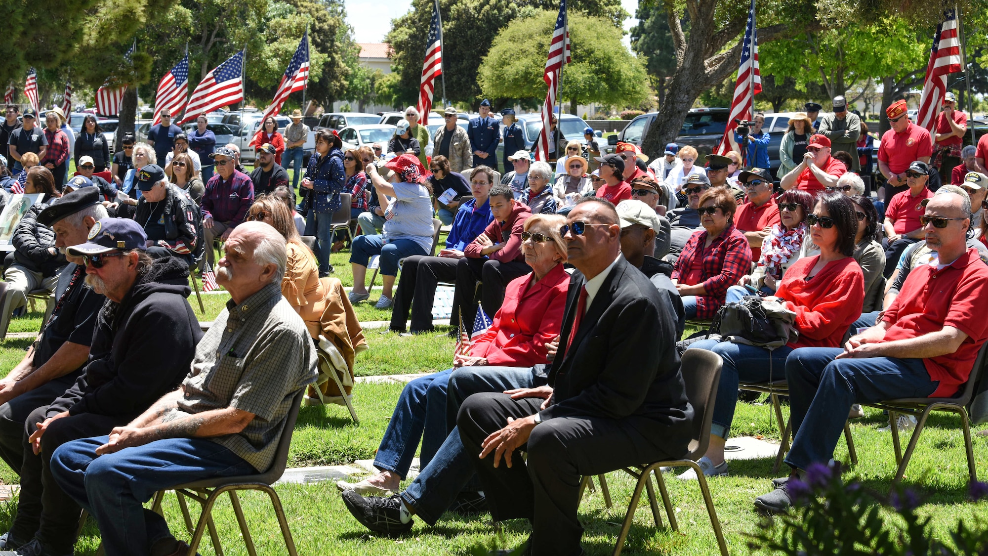 Community members gather for a Memorial Day ceremony May 27, 2019, at the Santa Maria Cemetery, Calif. Throughout the ceremony, service members and veterans who served in times of war were asked to stand as a way to show them appreciation for their sacrifice. (U.S. Air Force photo by Airman 1st Class Aubree Milks)