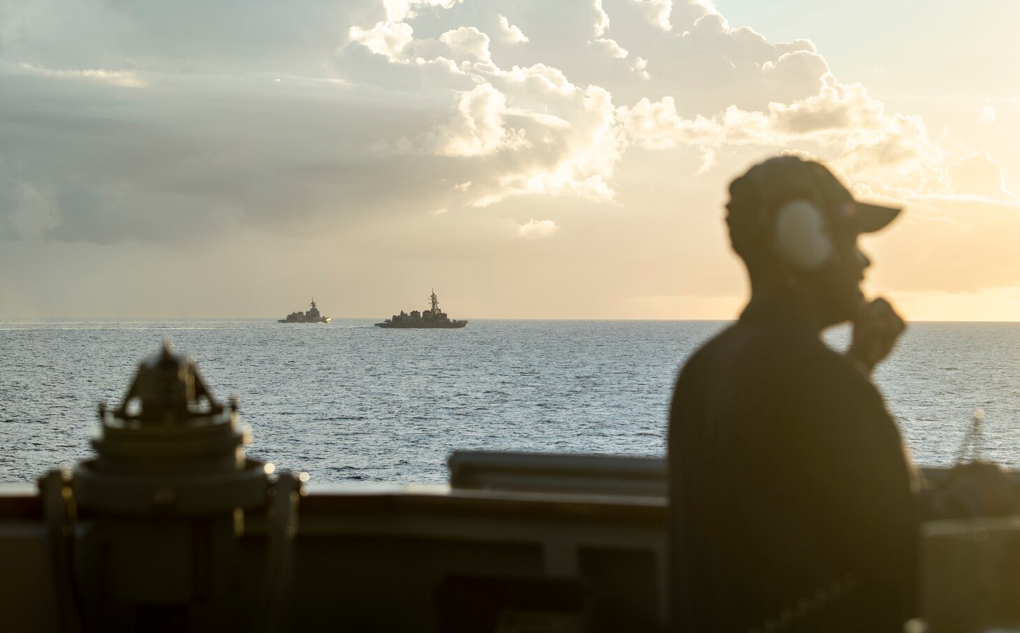 190529-N-CL550-0410 PHILIPPINE SEA (May 29, 2019) — Seaman Angelo Williams stands watch aboard the Arleigh Burke-class guided-missile destroyer USS Curtis Wilbur (DDG 54) while it steams in formation with Japanese Maritime Self Defense Force (JMSDF) destroyer JS Ariake (DD 109), right, and JMSDF destroyer JS Asahi. Curtis Wilbur is forward-deployed to the U.S. 7th Fleet area of operations in support of security and stability in the Indo-Pacific region.