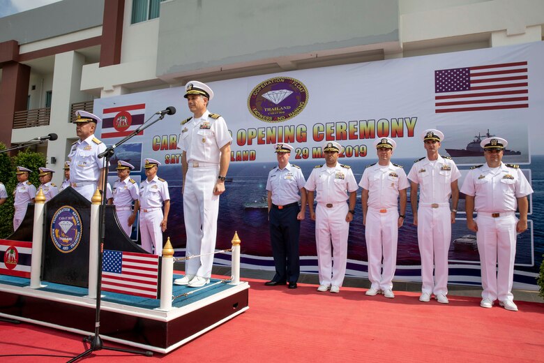 190529-N-AD347-1137 SATTAHIP NAVAL BASE, Thailand (May 29, 2019) - Capt. Matthew Jerbi, commodore of Destroyer Squadron 7, right, stands alongside Royal Thai Navy Rear Adm. Paisarn Meesri, commander of Frigate Squadron 2, during the opening ceremony for Cooperation Afloat Readiness and Training (CARAT) Thailand 2019. This year marks the 25th iteration of CARAT, a multinational exercise series designed to enhance U.S. and partner navies' abilities to operate together in response to traditional and non-traditional maritime security challenges in the Indo-Pacific region.
