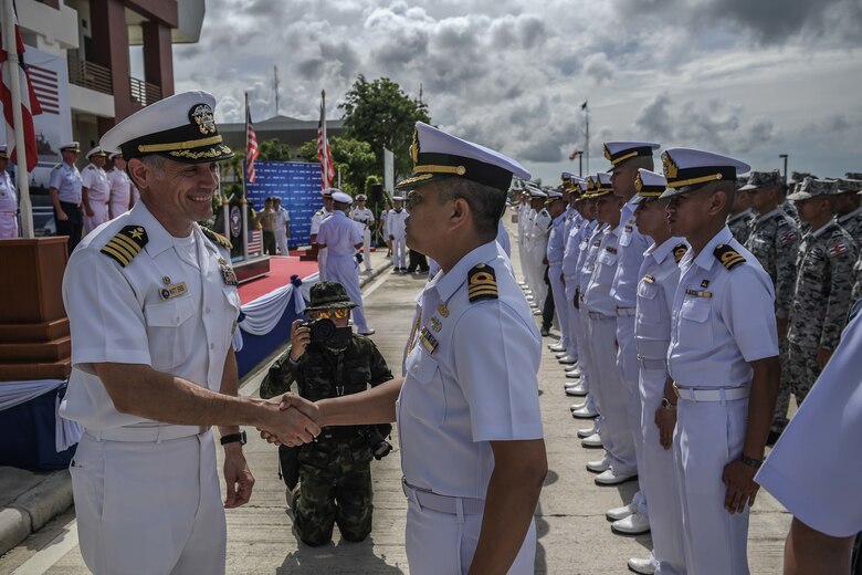 190529-N-XK398-1041 SATTAHIP NAVAL BASE, Thailand (May 29, 2019) Capt. Matthew Jerbi, commodore of Destroyer Squadron 7, shakes hands with a Royal Thai Navy officer after the opening ceremony for Cooperation Afloat Readiness and Training (CARAT) Thailand 2019. This year marks the 25th iteration of CARAT, a multinational exercise series designed to enhance U.S. and partner navies' abilities to operate together in response to traditional and non-traditional maritime security challenges in the Indo-Pacific region.