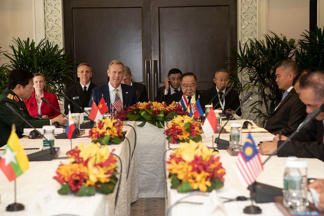 Acting Defense Secretary Patrick M. Shanahan sits at a table with Asian leaders.