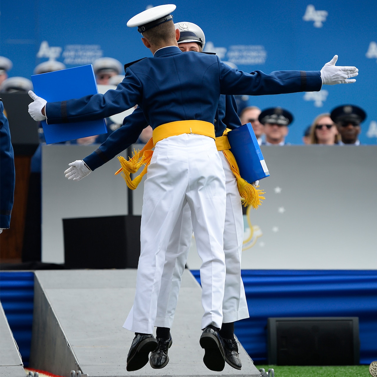 U.S. Air Force Academy graduates celebrate after receiving their diplomas.