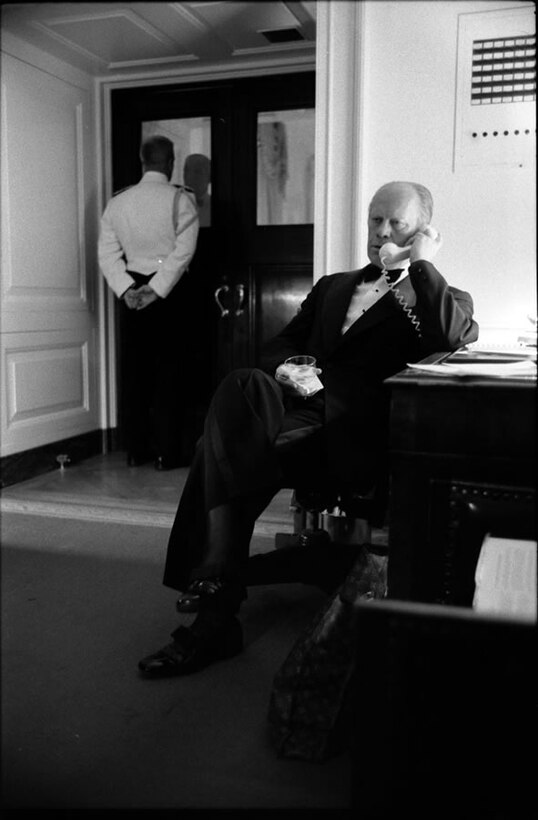 President Ford takes a phone call about plans to retake the S.S. Mayaguez and its crew during a White House dinner