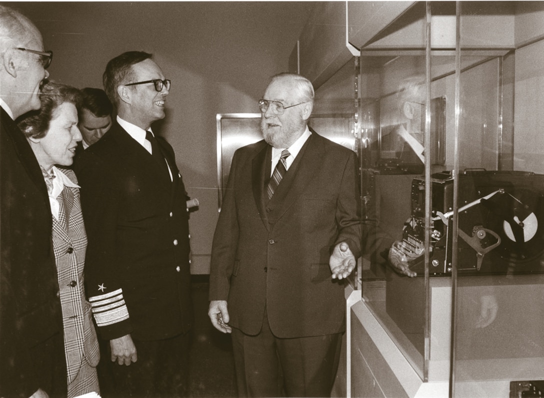 VADM Inman and Ms. Ann Caracristi listen to Hall of Honor Cryptologist Frank B. Rowlett describe the ENIGMA machine