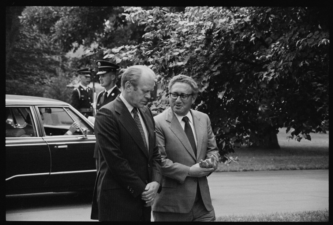 President Gerald Ford and Secretary of State Henry Kissinger conversing on the White House grounds