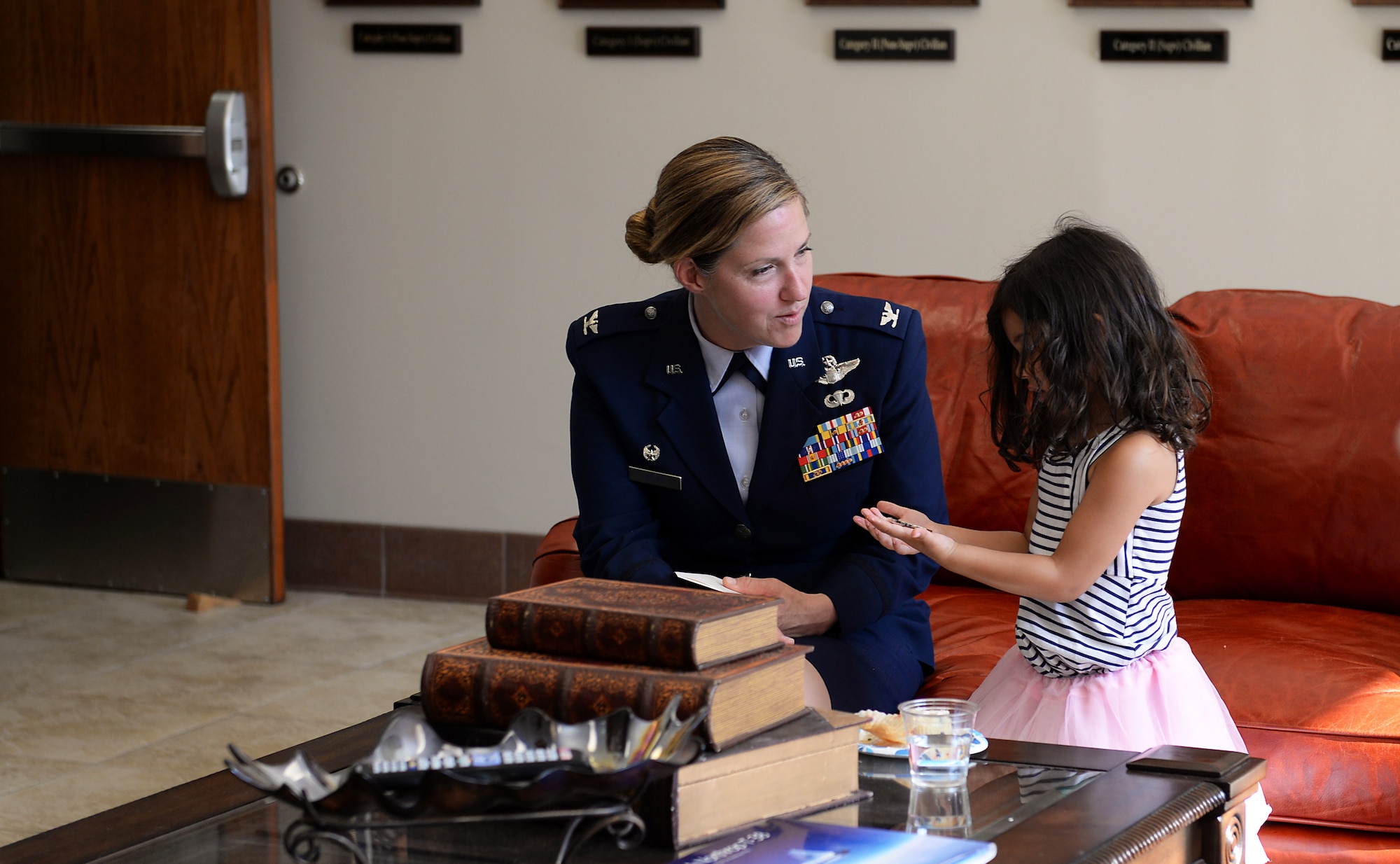 Col. Samantha Weeks, 14 Flying Training Wing commander, gives Aeliana, daughter of 1st Lt. David Albandoz, 198th Airlift Squadron C-130H pilot, Puerto Rico a coin after a Memorial Day Ceremony May 28, 2019, on Columbus Air Force Base, Miss. Aeliana visited Columbus AFB with her mother, Nicoleta Padureanu, to attend a Memorial Day Ceremony in honor of her late father where his name was unveiled on the memorial wall in the Richard “Gene” Smith Plaza. (U.S. Air Force photo by Airman 1st Class Hannah Bean)