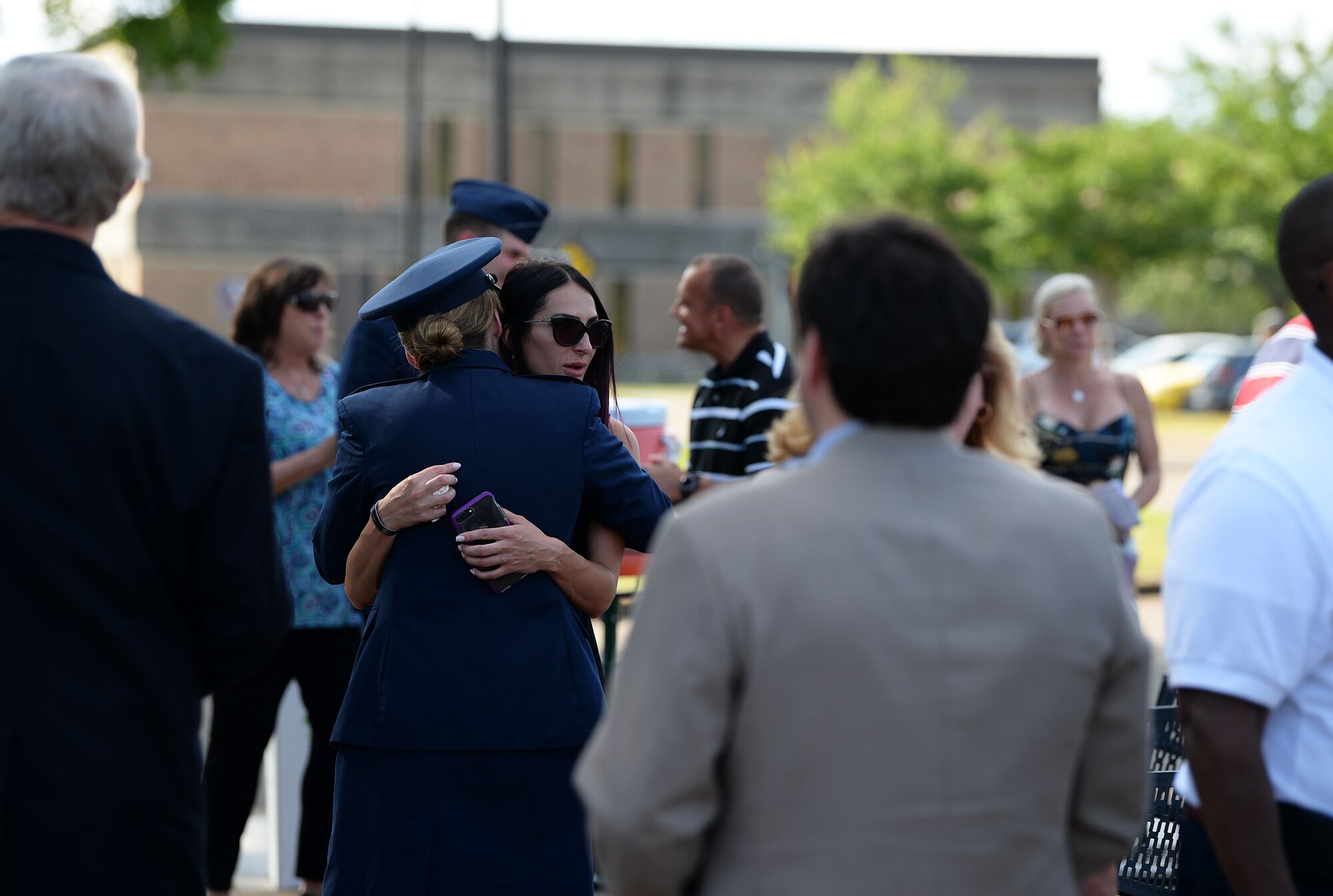 Col. Samantha Weeks, 14 Flying Training Wing commander, hugs Nicoleta Padureanu, widow of 1st Lt. David Albandoz, 198th Airlift Squadron C-130 Hercules pilot, Puerto Rico during a Memorial Day Ceremony May 28, 2019, at the Richard “Gene” Smith Plaza on Columbus Air Force Base, Miss. Nicoleta and her daughter, Aeliana, visited Columbus AFB to attend a Memorial Day Ceremony in his honor where his name was unveiled on the memorial wall in the Richard “Gene” Smith Plaza. (U.S. Air Force photo by Airman 1st Class Hannah Bean)