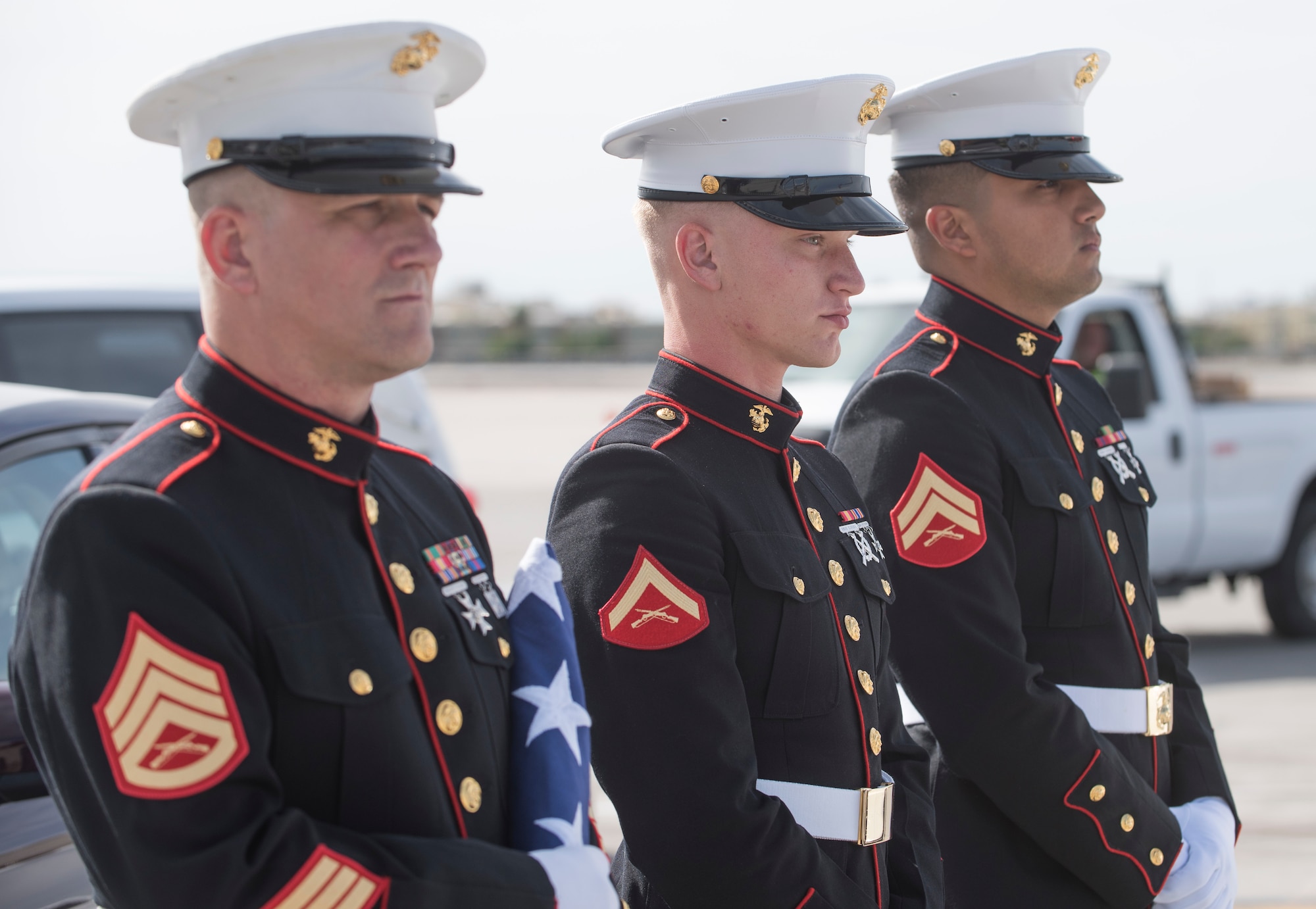 U.S. Marine Staff Sgt. Robert Martin, 6th Engineer Support Battalion Bulk Fuel Company Charlie, Site Support Phoenix maintenance chief (left), Lance Cpl. Kyle Pierce and Cpl. Tristan Garivay (right), Alpha Company administrative specialists, Headquarters and Support Battalion, Marine Corps Installations East, stand ready to receive a dignified transfer May 17, 2019, at the Phoenix Sky Harbor International Airport, Ariz.