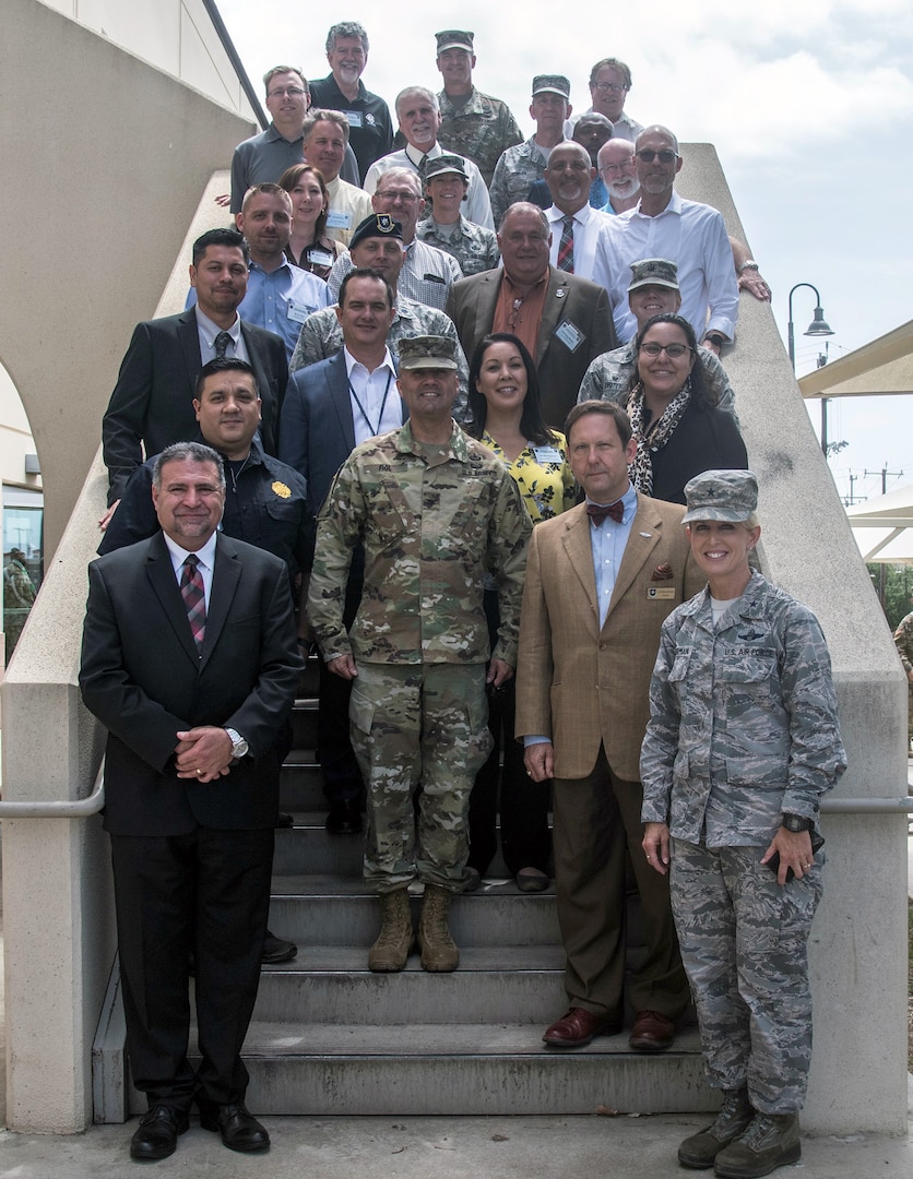 502nd Air Base Wing Honorary Commanders and their respective commanders stop to take a photo after lunch at the Slagel dining facility at Joint Base San Antonio-Fort Sam Houston May 21