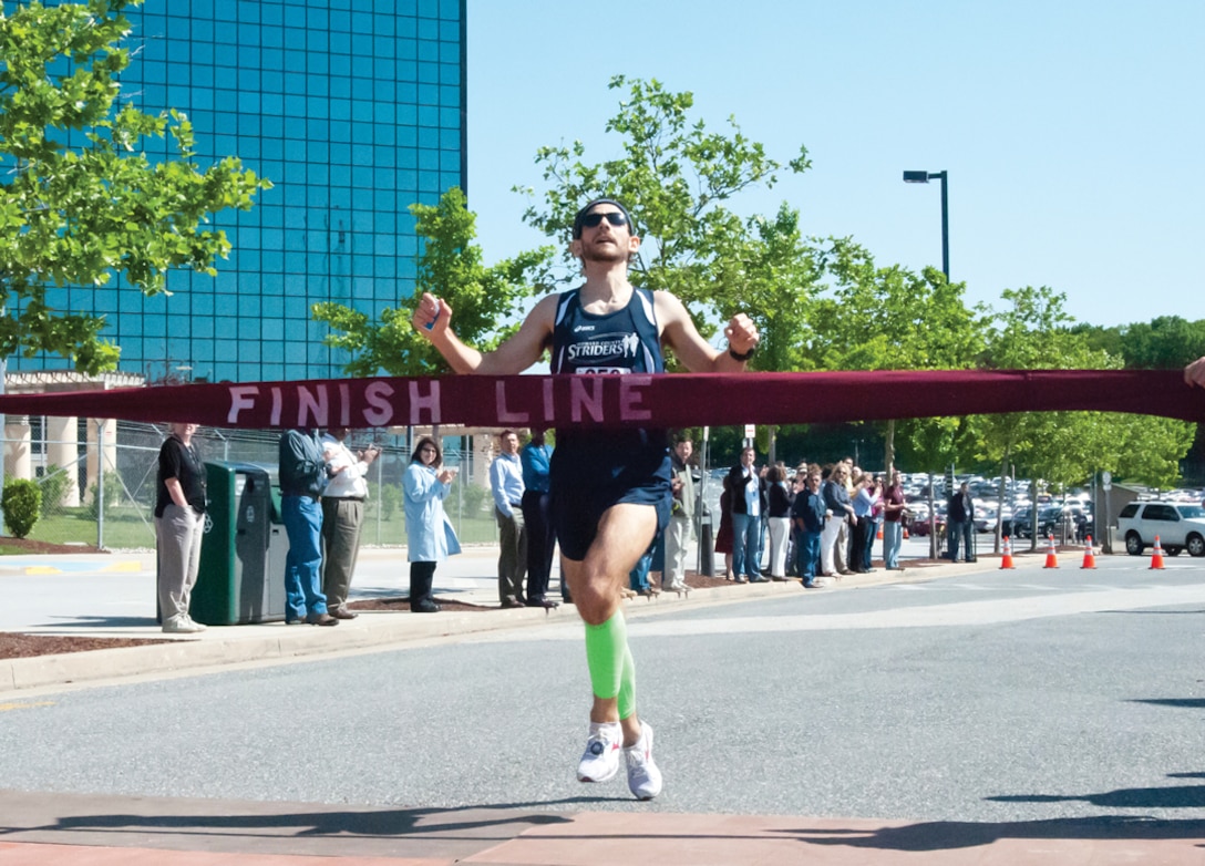 The First Athlete Crosses the Finish Line at the 2012 Armed Forces Week 5K Race