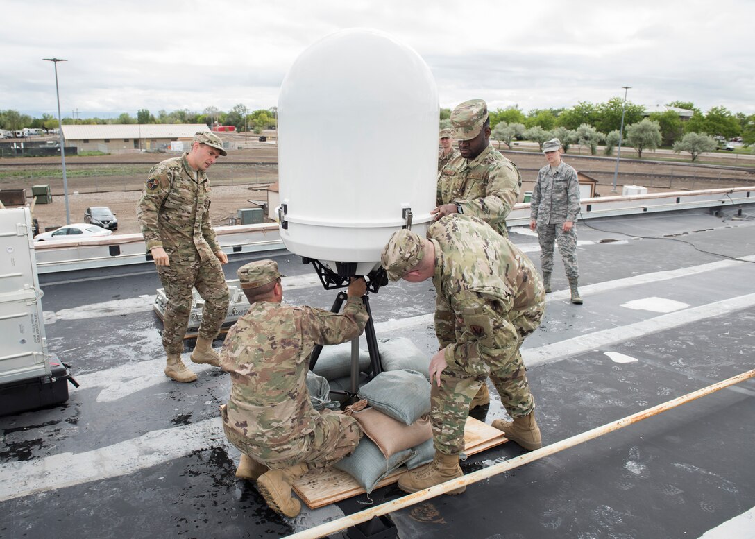 Mountain Home Air Force Base and Hurlburt Field weather system personnel assemble a Doppler system May 25, 2019, at Mountain Home Air Force Base, Idaho. The is the first time the Doppler system has been installed on a Continental United States base. (U.S. Air Force photo by Senior Airman Tyrell Hall)