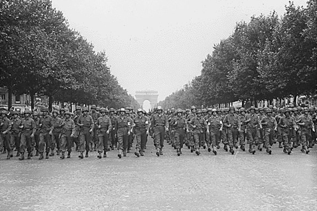Soldiers march down the Champs-Elysees.