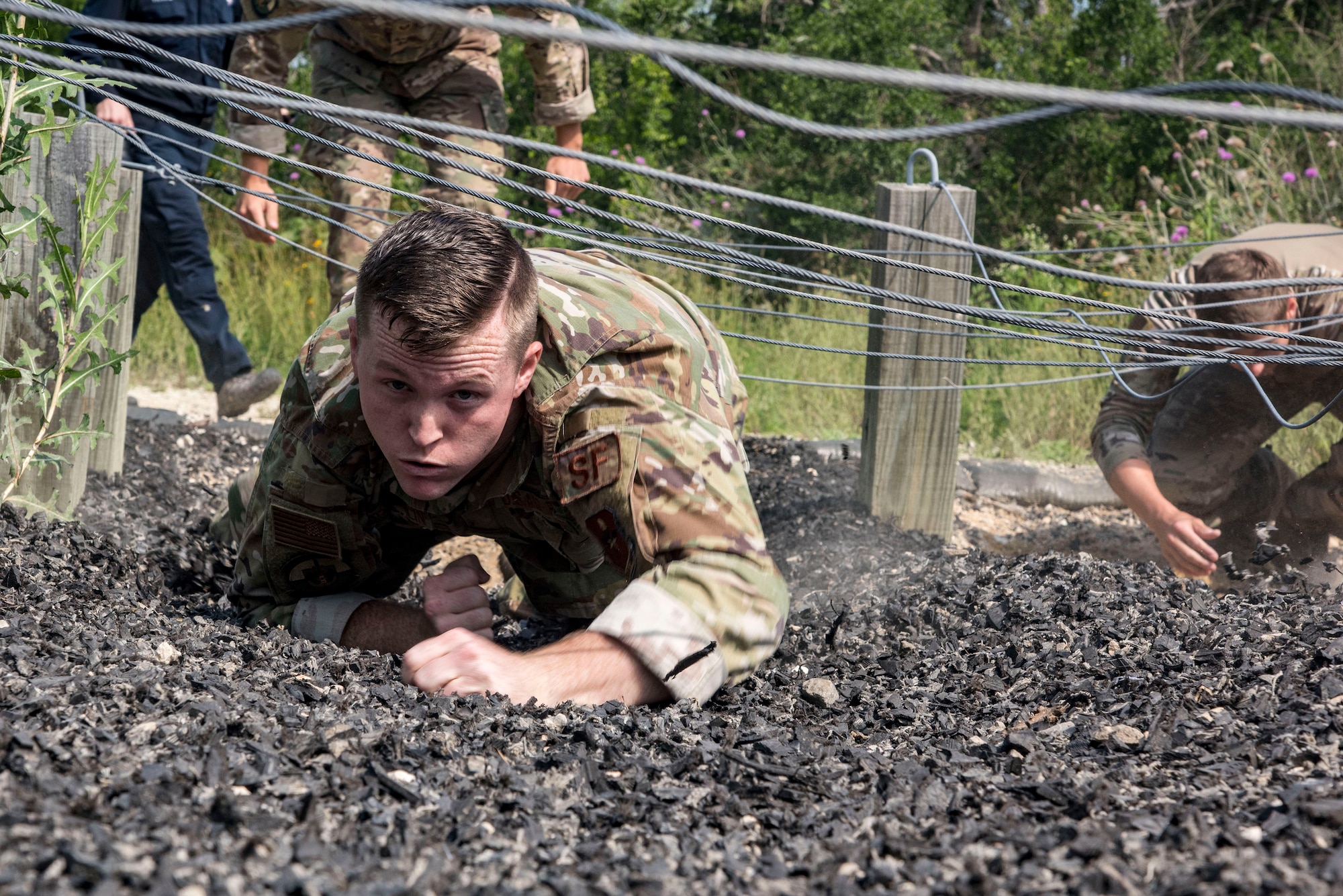 Senior Airman William McLaughlin, 502nd Security Forces Squadron combat arms instructor, competes in an obstacle course race during Police Week May 14, 2019, at Joint Base San Antonio, Texas. National Police Week dates back to 1962, when President John F. Kennedy proclaimed May 15 as National Peace Officers Memorial Day. That same year, Congress established by joint resolution the week in which May 15 falls as National Police Week.