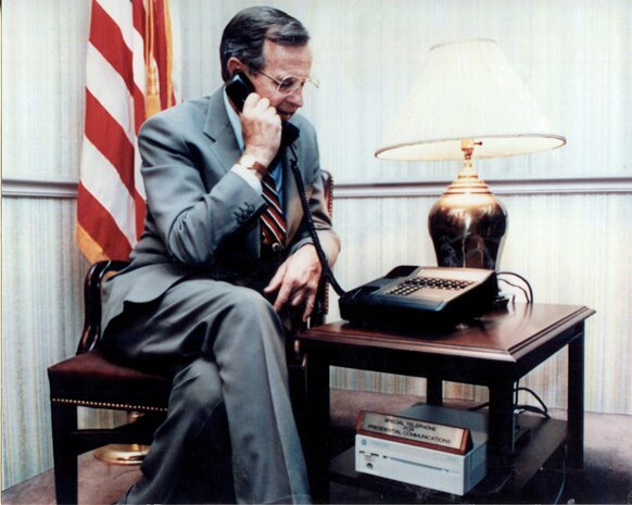 President H. W. Bush confers in confidence using a STU III device