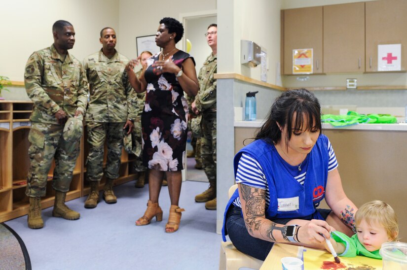 Vivian Gadson, 628th Force Support Squadron flight chief of fleet and family services, shows one of the new pre-toddler rooms to Col. Terrence Adams, 628th Air Base Wing commander, and Chief Master Sgt. Todd Cole, 628th Air Base Wing command chief, during a tour after the ribbon cutting ceremony for the expansion of the child development center at the Joint Base Charleston Air Base, S.C.