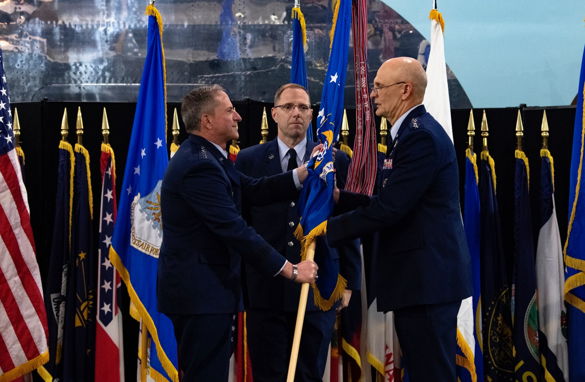 Air Force Chief of Staff Gen. David L. Goldfein passes the flag to Gen. Arnold W. Bunch, Jr. as Bunch assumes command of Air Force Materiel Command during a ceremony at the National Museum of the United States Air Force, Wright-Patterson Air Force Base, Ohio, May 31, 2019. Bunch takes command of Air Force Materiel Command after serving as the Deputy to the Assistant Secretary of the Air Force for Acquisition, Technology, and Logistics at the Pentagon. (U.S. Air Force photo/Scott M. Ash)