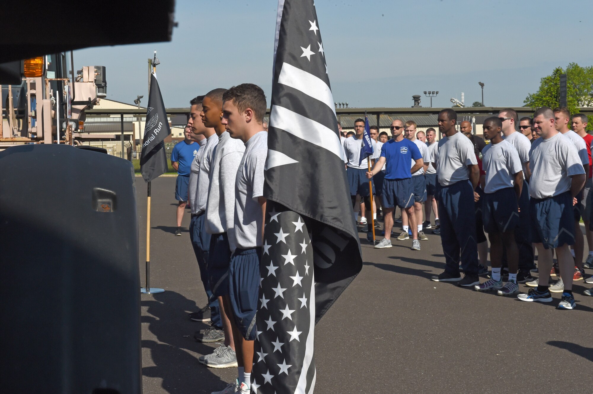 Airmen place devices for each fallen Port Dawg on a chain stretched across two forklifts during the opening ceremony at Joint Base McGuire-Dix-Lakehurst, N.J. May 17, 2019. The Port Dawg Memorial Run honors aerial porters who lost their lives the previous year. (U.S. Air Force photo by Staff Sgt. Sarah Brice)