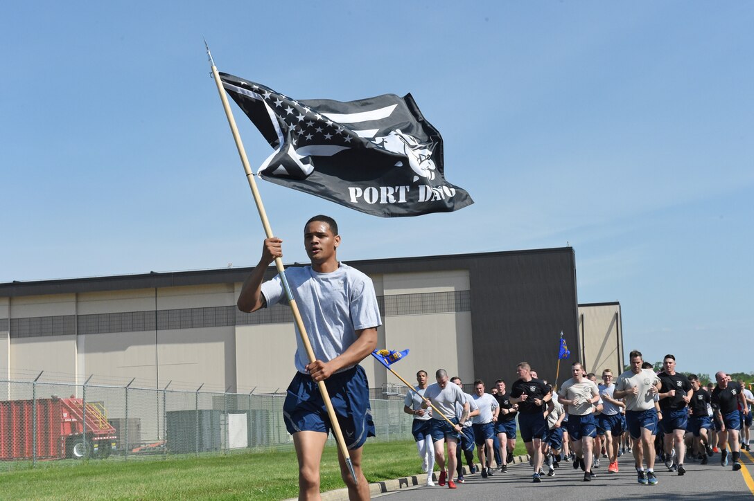 Airmen run in formation during the 5th Annual Port Dawg Memorial 5K Run at at Joint Base McGuire-Dix-Lakehurst, N.J. May 17, 2019. The Port Dawg Memorial Run honors aerial porters who lost their lives the previous year. (U.S. Air Force photo by Staff Sgt. Sarah Brice)