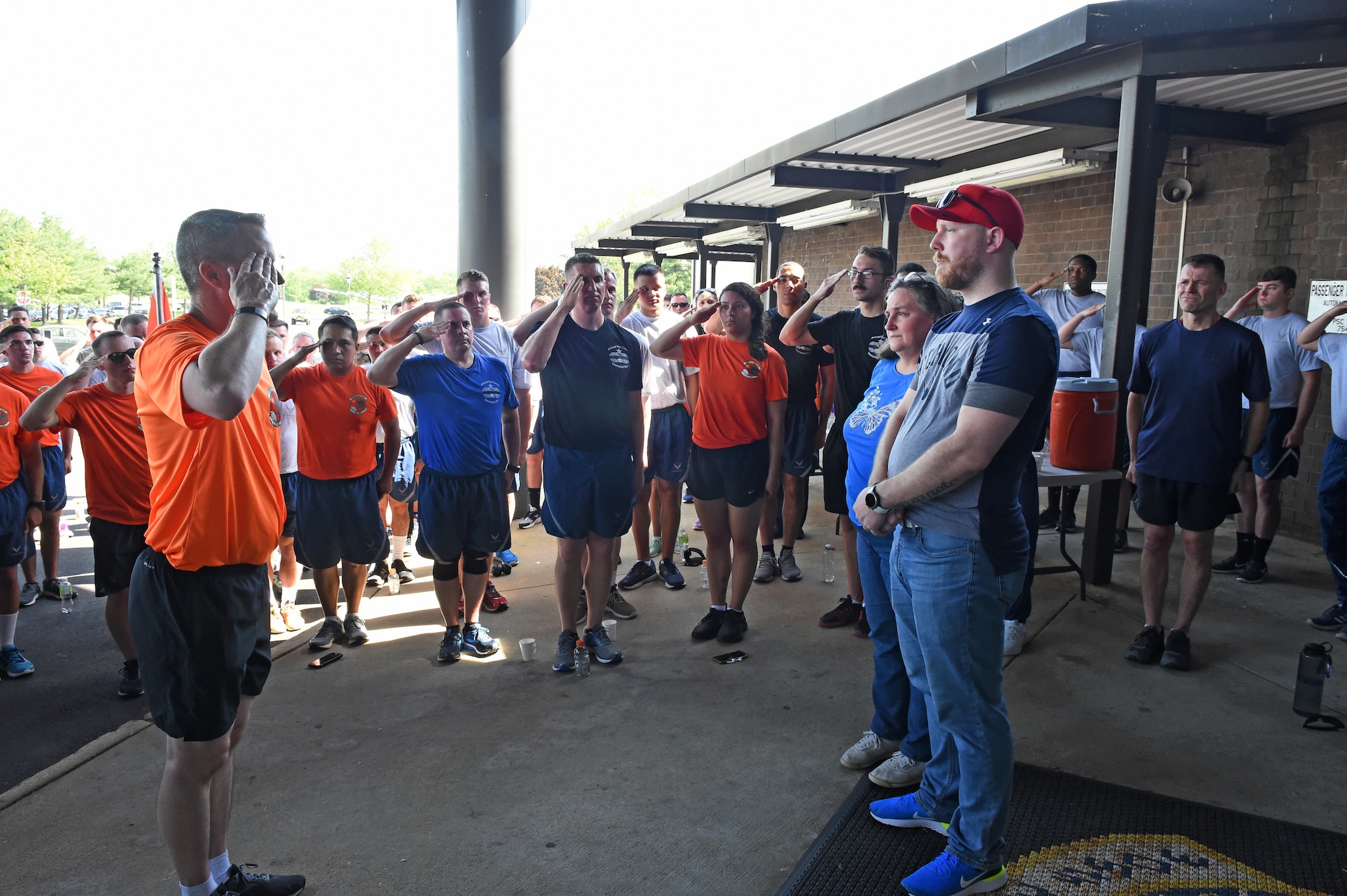 Participants of the Port Dawg Memorial Run honor the family of fallen Port Dawg Tech.Sgt. Curtis Eccleston with a salute at Joint Base McGuire-Dix-Lakehurst, N.J. May 17, 2019. The Port Dawg Memorial Run honors aerial porters who lost their lives the previous year. (U.S. Air Force photo by Staff Sgt. Sarah Brice)