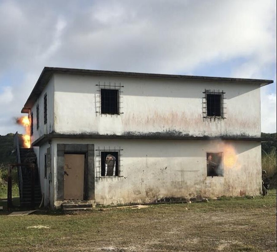 U.S. Marines of Combat Engineer Platoon and Company A, 1st Battalion, 4th Marines, 1st Marine Regiment, conduct a simultaneous exterior urban breach at the Naval Special Warfare BreacherTrainer, Naval Base Guam, Mar. 13, 2019. Combat Engineers and Company A assaultmenexecuted three days of urban breaching operations, to include joint live fire training with Navy Explosive Ordnance technicians from Explosive Ordnance Disposal Mobile Unit 5, Detachment Marianas.