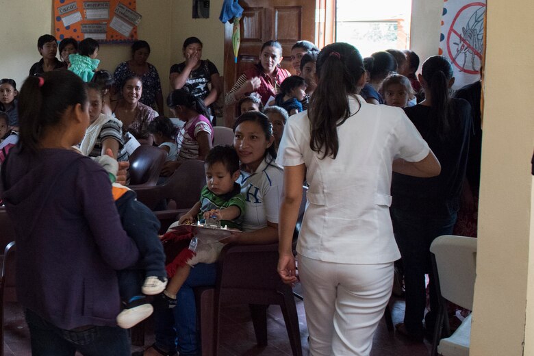 Mothers and their children wait to be seen by medics from Joint Task Force - Bravo during a Pediatric Medical Readiness Training Exercise May 23, 2019 in La Paz, Honduras. MEDRET missions allow JTF-B medical personnel to train in their areas of expertise, while providing a service and strengthening partnership with the host nation. The service members saw approximately 120 patients during the mission. (U.S. Air Force photo by Staff Sgt. Eric Summers Jr.)
