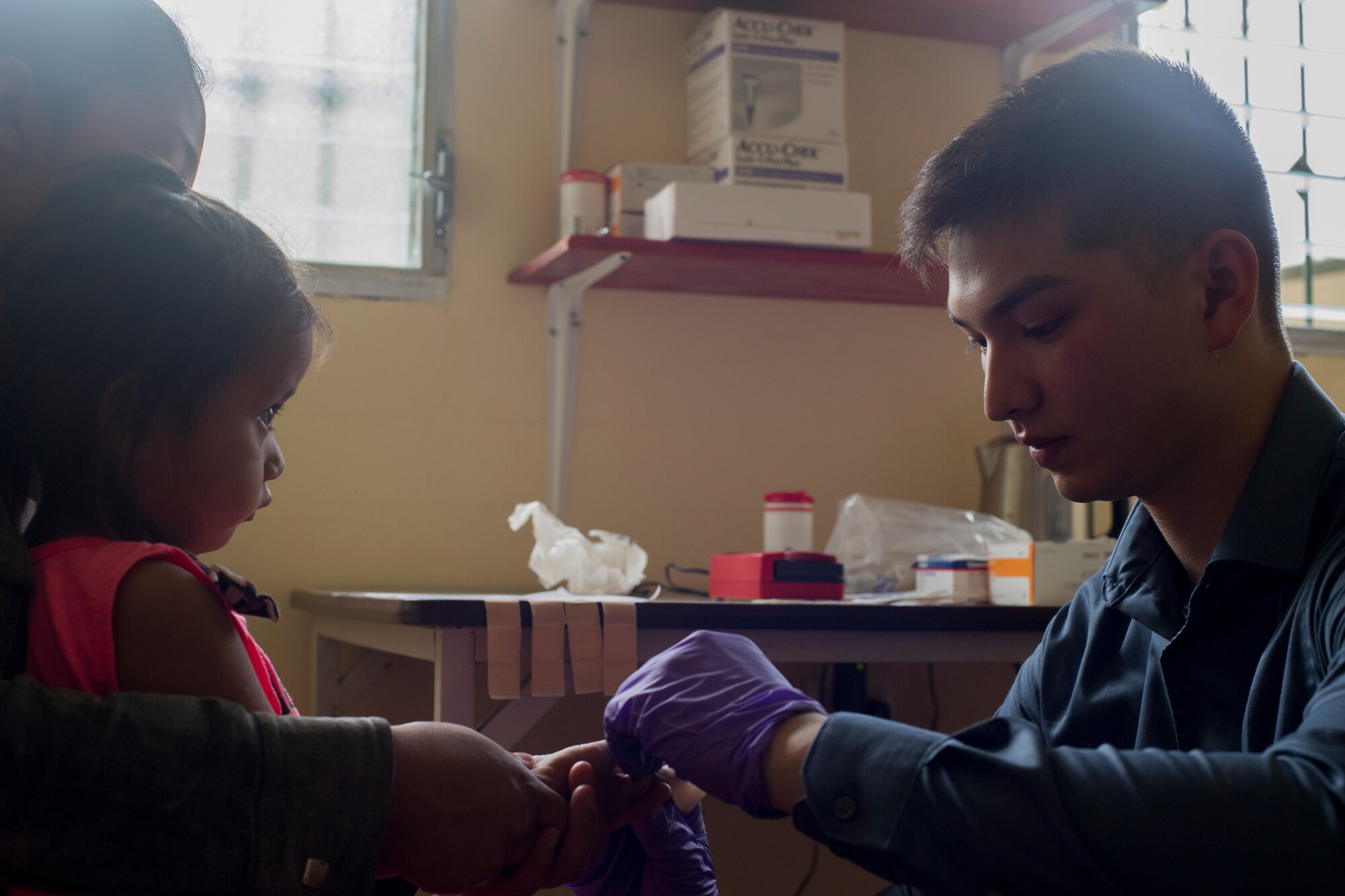 U.S. Army Spc. Colin Yap, Joint Task Force – Bravo Medical Element medic, pricks the finger of young girl to measure her hemoglobin levels during a Pediatric Medical Readiness Training Exercise May 23, 2019 in La Paz, Honduras. MEDRET missions allow JTF-B medical personnel to train in their areas of expertise, while providing a service and strengthening partnership with the host nation. The service members saw approximately 120 patients during the mission. (U.S. Air Force photo by Staff Sgt. Eric Summers Jr.)