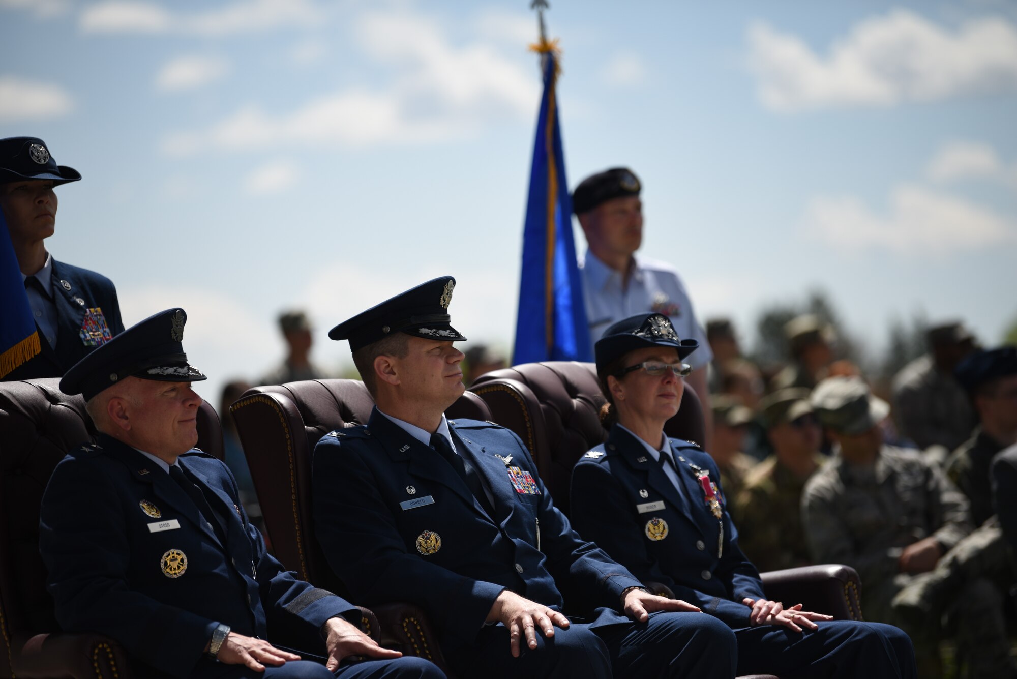 Major Gen. Fred Stoss, 20th Air Force commander, Col. Peter Bonetti, 90th Missile Wing commander, and Col. Stacy Jo Huser, 90th Missile Wing outgoing commander, spectate during the change of command ceremony on the Argonne Parade Field at F.E. Warren Air Force Base, Wyo., May 31, 2019. The change of command exhibited multiple group formations marching, as well as a cannon blast. (U.S. Air Force photo by Staff Sgt. Ashley N. Sokolov)