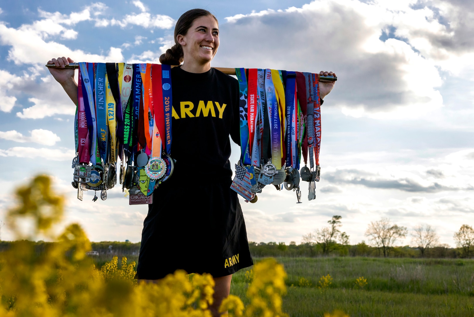 Sgt. Ayrin Hamner-Ripperger, the administration and supply non-commissioned officer with the Iowa Army National Guard’s 831st Engineer Company, stands at Camp Dodge, Iowa, with the race medals she has earned on her quest to run a half-marathon in all 50 states. Hamner-Ripperger is slated to finish her quest in October, when she runs in South Dakota.