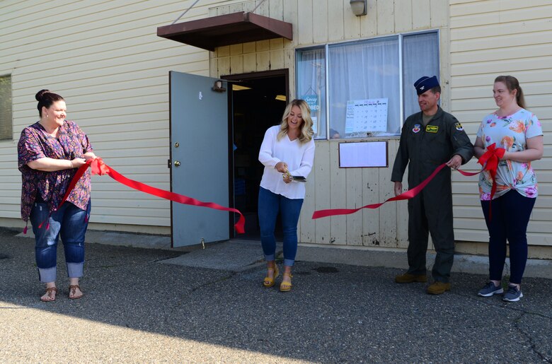 A photo of people cutting a ribbon in front of the thrift store on Beale.