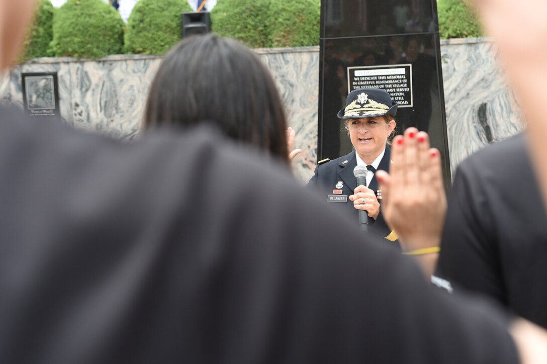 Brig. Gen. Kris Belanger, Commanding General, 85th U.S. Army Reserve Support Command, swears in new Army recruits during the Village of Norridge Memorial Day commemoration, Mar. 26, 2019.