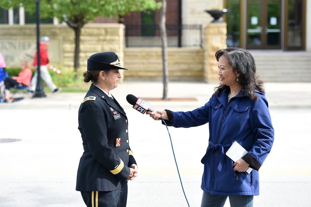 Brig. Gen. Kris Belanger, right, Commanding General, 85th U.S. Army Reserve Support Command, speaks on Memorial Day during an interview with Fox 32 News during the Village of Arlington Heights Memorial Day commemoration, Mar. 27, 2019.