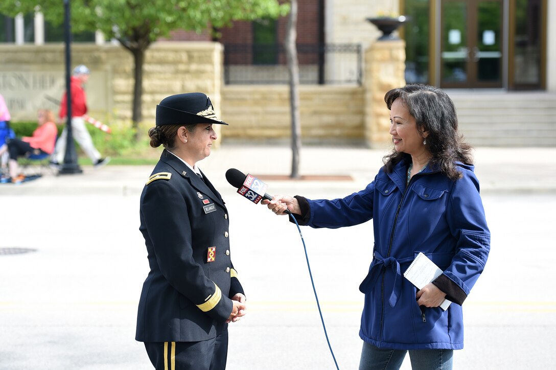 Brig. Gen. Kris Belanger, right, Commanding General, 85th U.S. Army Reserve Support Command, speaks on Memorial Day during an interview with Fox 32 News during the Village of Arlington Heights Memorial Day commemoration, Mar. 27, 2019.