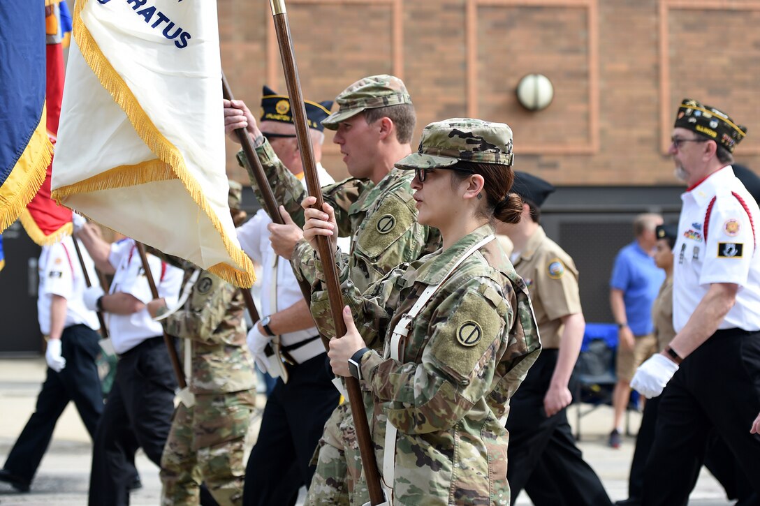 Sgt. Andrew Raynor, left, and Sgt. Maribel Meraz, both assigned to the 85th U.S. Army Reserve Support Command, march in the Village of Arlington Heights Memorial Day parade, Mar. 27, 2019.