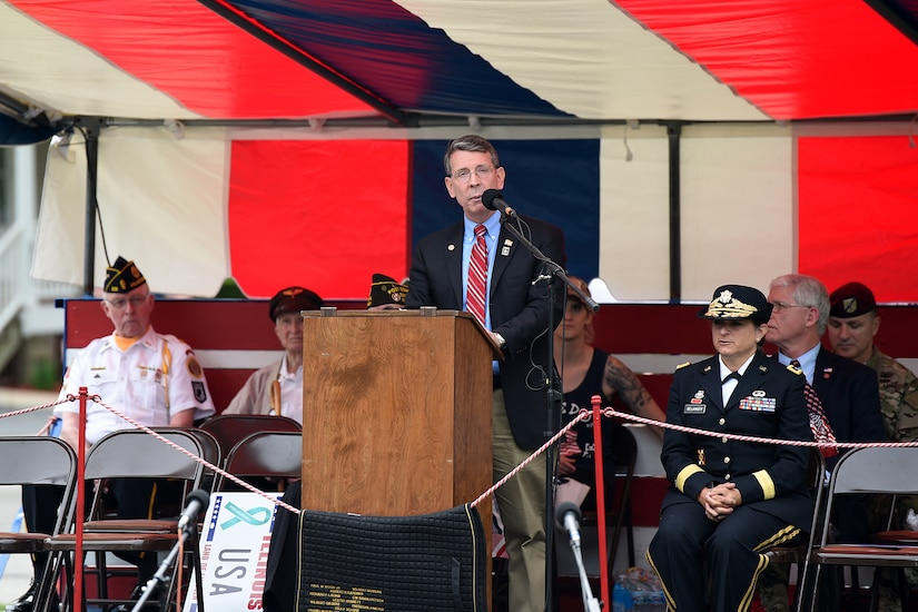 Mayor Thomas Hayes, Mayor of Arlington Heights and Army veteran, gives remarks during the Village of Arlington Heights Centennial Memorial Day commemoration, Mar. 27, 2019.