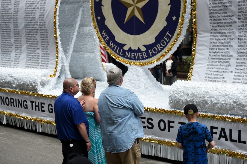 A Gold Star Family takes a moment in front of the Gold Star Family float following the City of Chicago Memorial Day parade, Mar. 25, 2019.